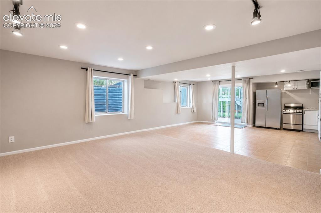 Image 24 of 43: Second living room/kitchenette with walk out - basement
