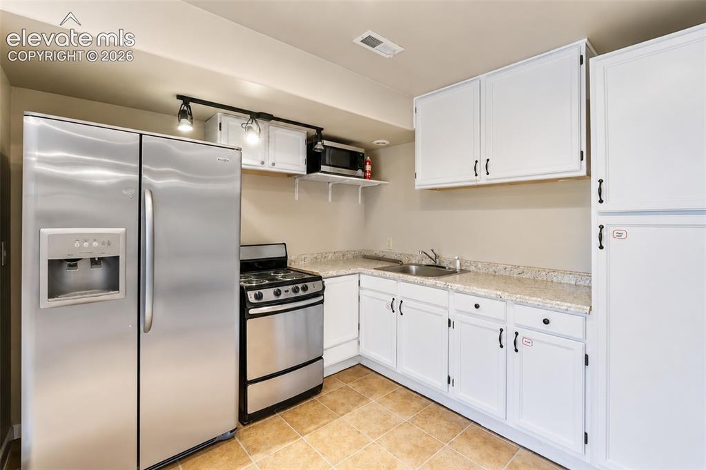 Image 26 of 43: Kitchenette with walk out - basement