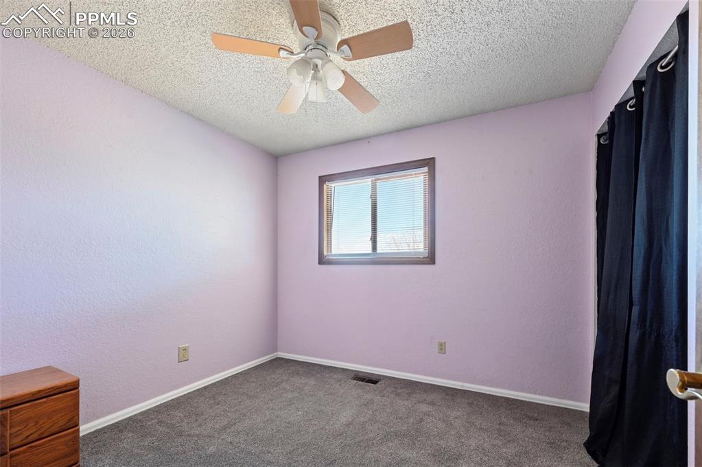 Image 10 of 27: This room features carpeted flooring, a window with blinds, and a ceiling f