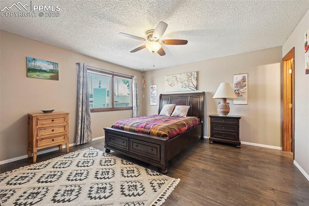 Image 13 of 27: This inviting room features wood-look flooring, a window with exterior view