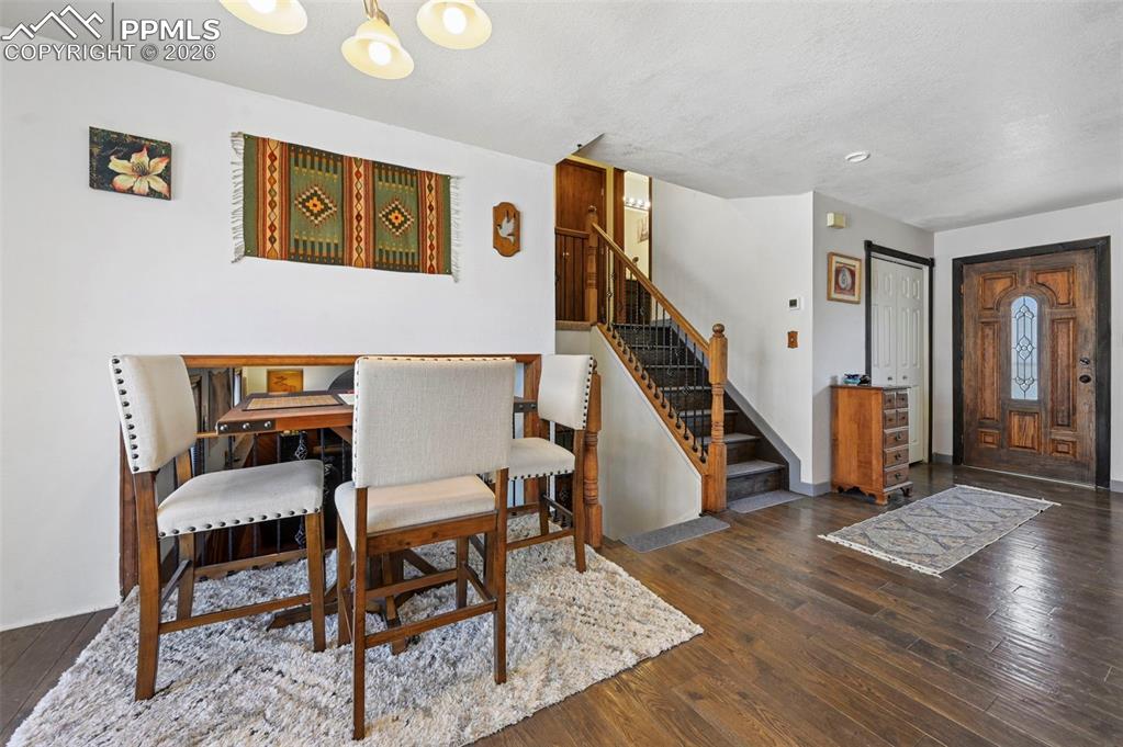 Image 9 of 27: The property features wood flooring throughout, a wooden staircase with a b