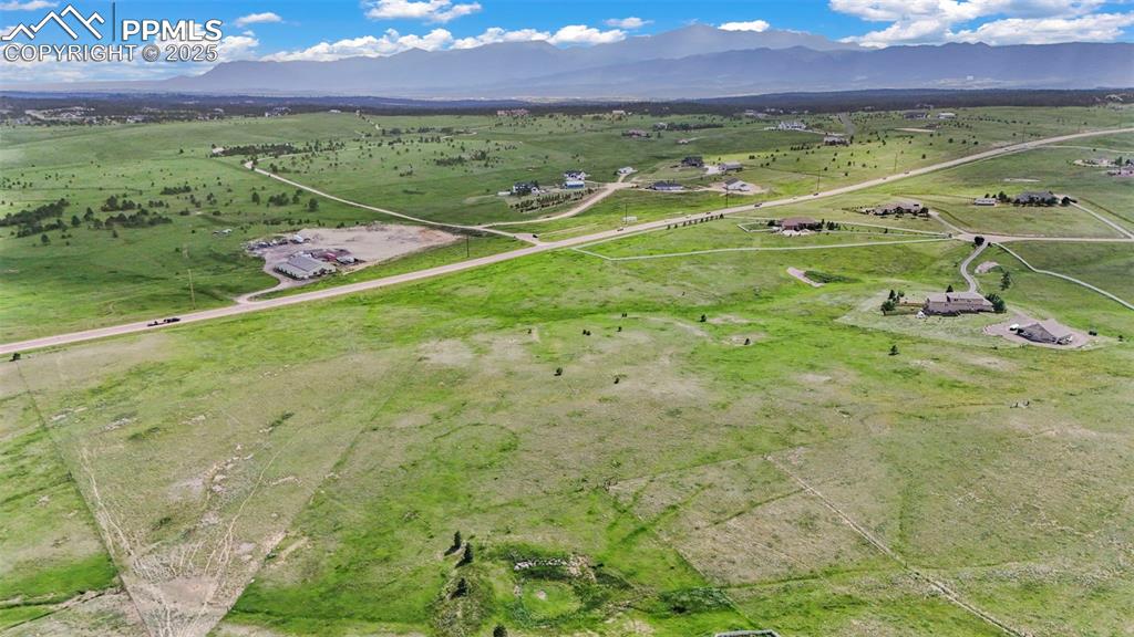 Image 11 of 23: Aerial view of property and surrounding area with rural landscape and mount