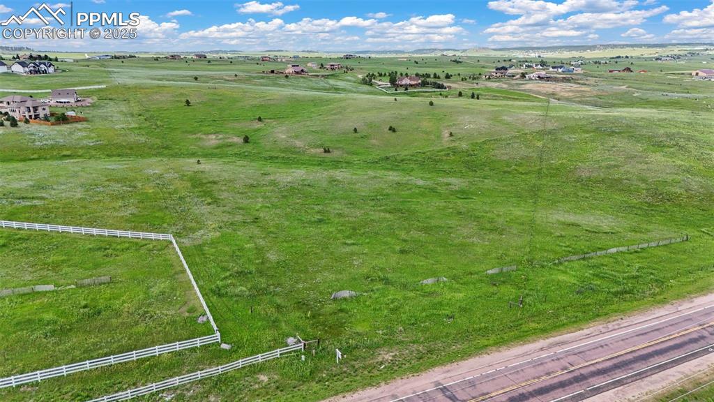 Image 13 of 23: Aerial view of sparsely populated area with a pastoral area