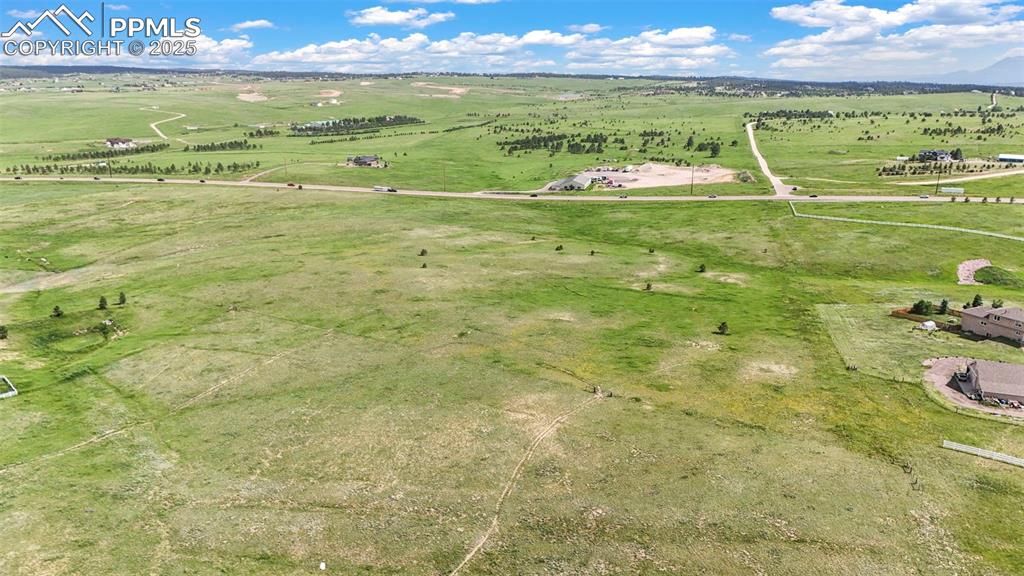 Image 18 of 23: Aerial view of sparsely populated area featuring agricultural land