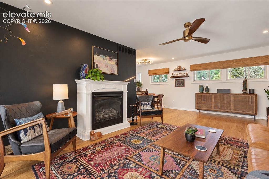 Image 11 of 36: Stunning family room with gas fireplace and unmatched Pikes Peak views