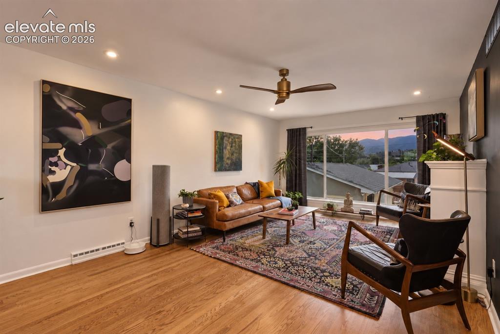 Image 12 of 36: Stunning family room with gas fireplace and unmatched Pikes Peak views