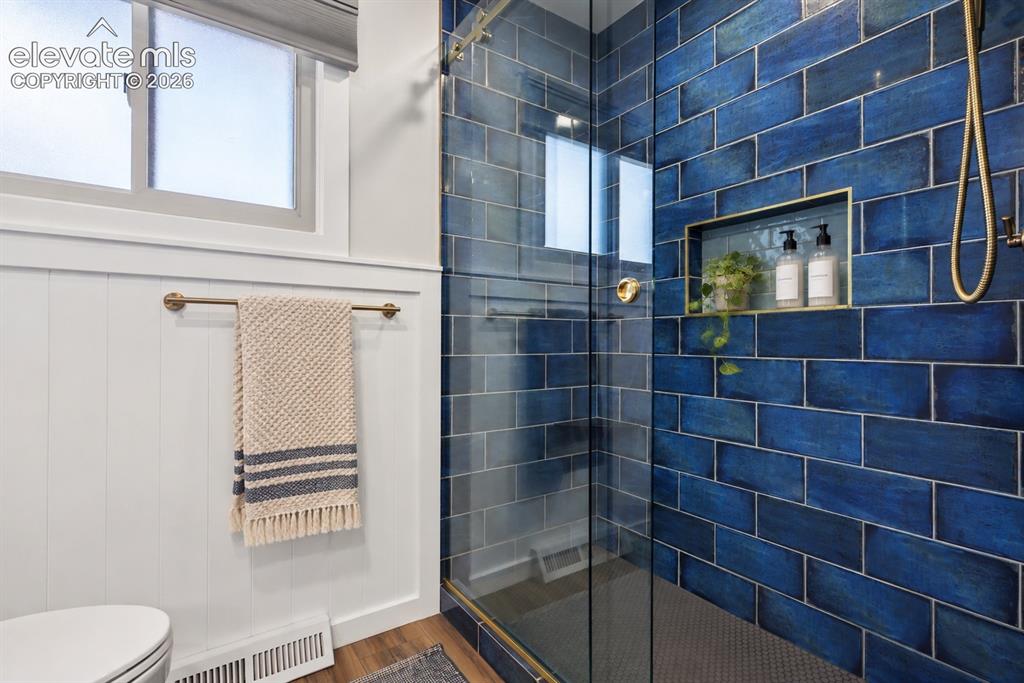 Image 17 of 36: Stunning remodeled bath featuring custom artisan tile imported from Spain a