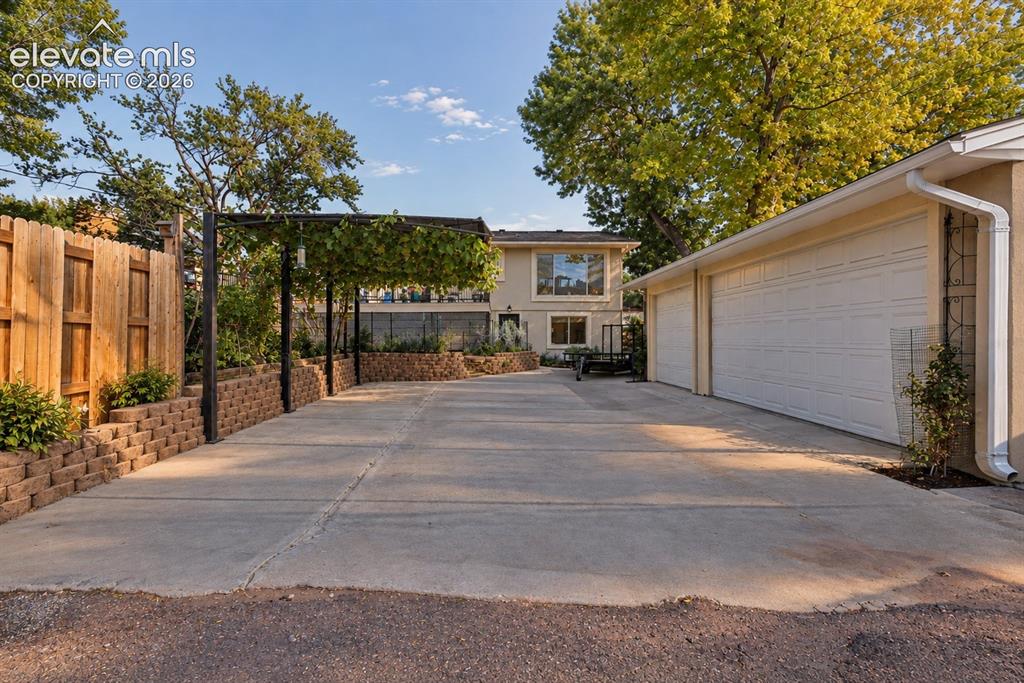 Image 35 of 36: Oversized detached 3-car garage with exceptional space for vehicles, storag