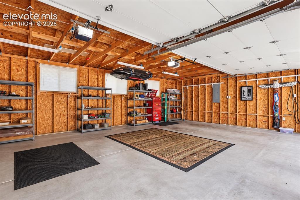 Image 36 of 36: Oversized detached 3-car garage with exceptional space for vehicles, storag