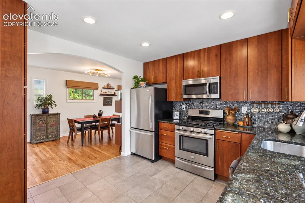 Image 9 of 36: Beautifully appointed with walnut soft-close cabinetry, built-in pantry, gr