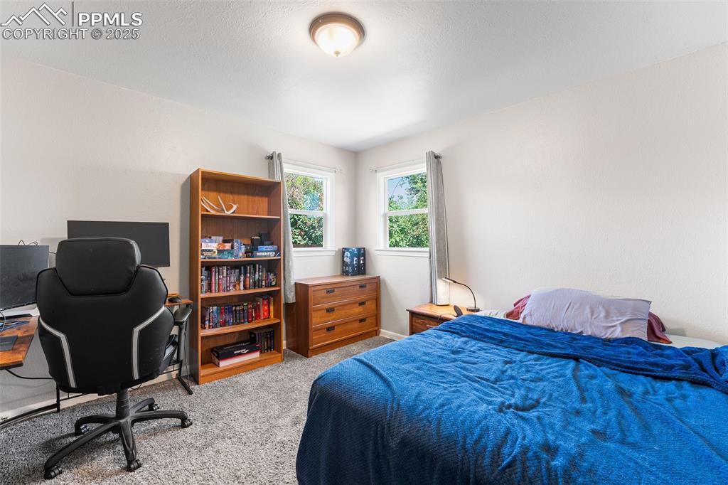 Image 13 of 24: Bedroom featuring carpet and a desk