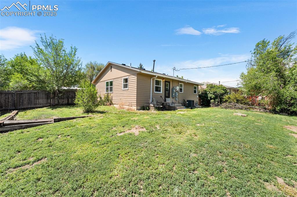 Image 17 of 24: Rear view of property featuring cooling unit and entry steps