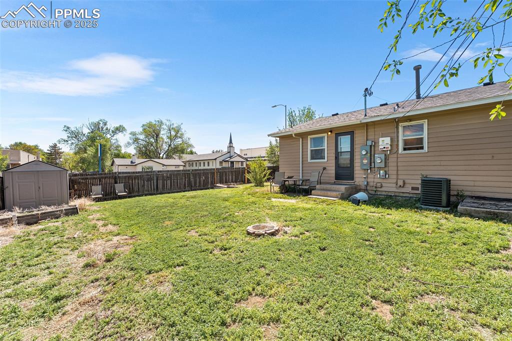 Image 21 of 24: View of yard with central AC unit