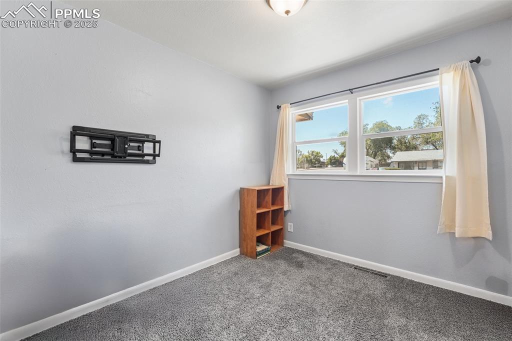 Image 9 of 24: Spare room featuring carpet flooring and baseboards