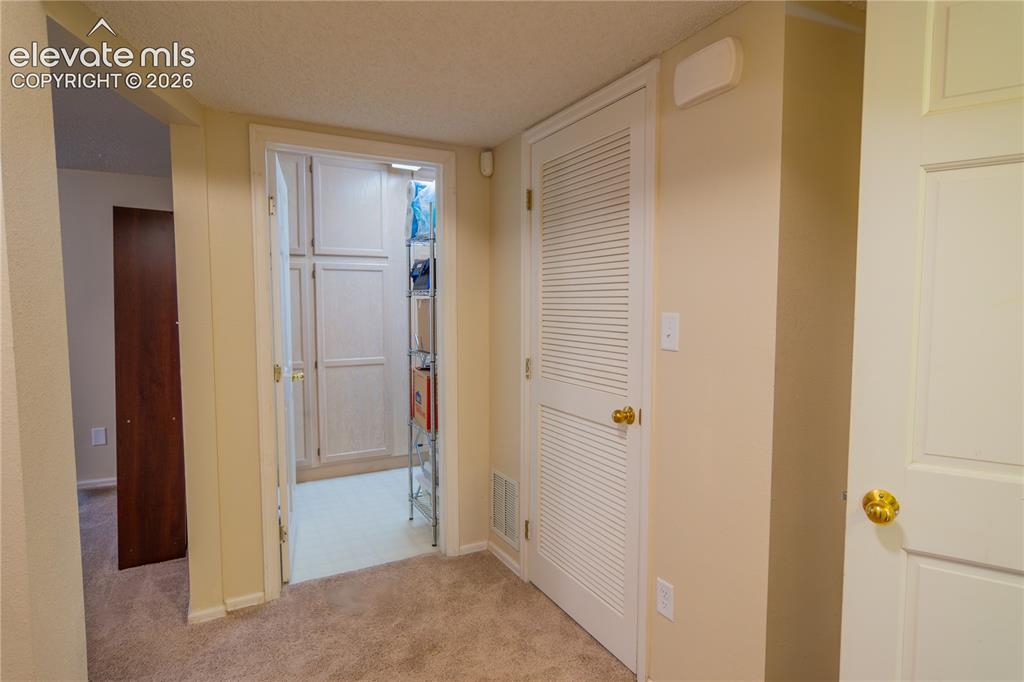 Image 31 of 42: Built-in cabinetry within a dedicated storage area, solid core interior doo