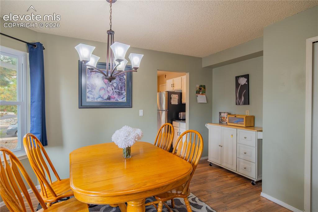 Image 9 of 42: Wood-finish flooring with light green wall tones