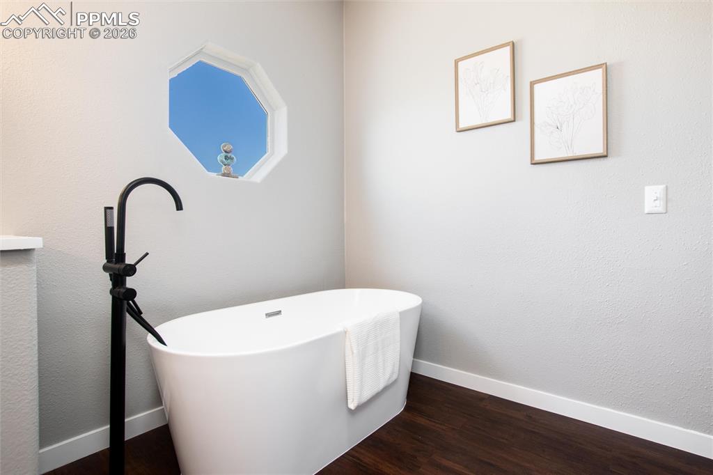 Image 27 of 50: Primary bedroom with en suite bath