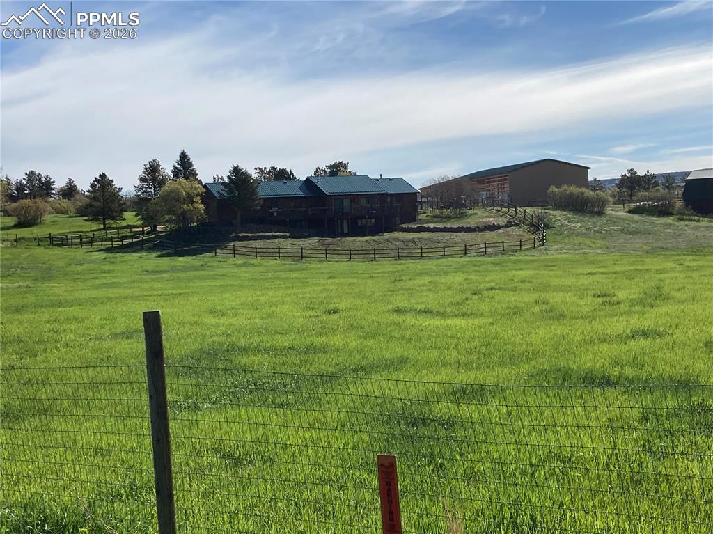 Image 37 of 40: View of yard with a rural view in summer