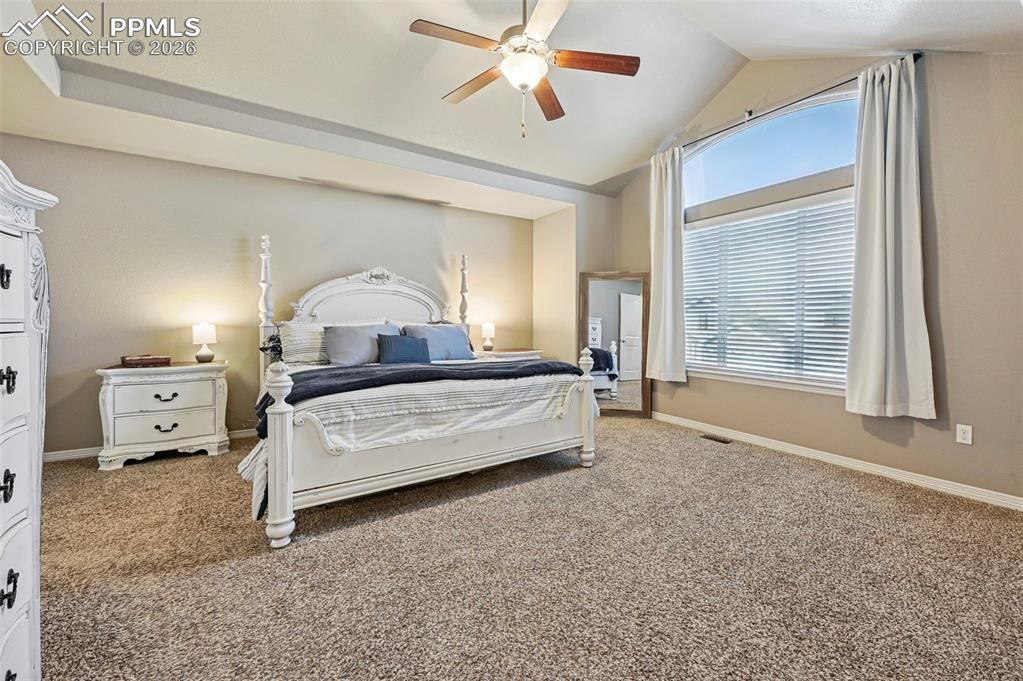 Image 21 of 38: Carpeted bedroom with baseboards and a ceiling fan