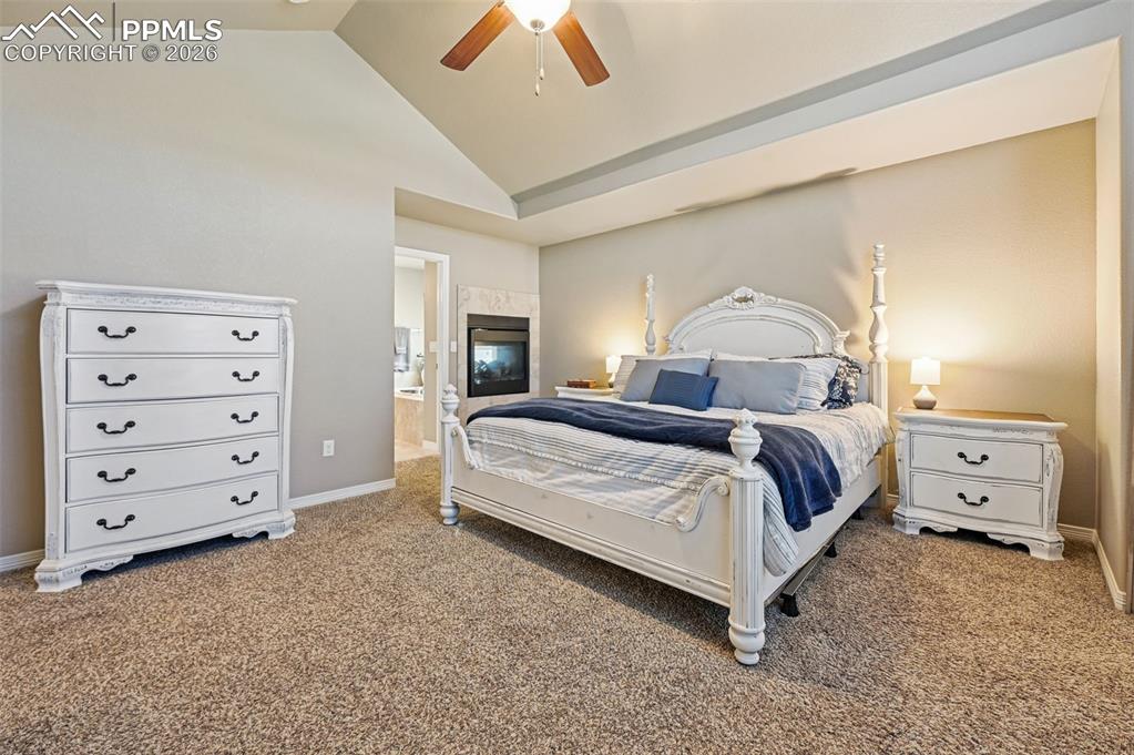 Image 22 of 38: Bedroom featuring vaulted ceiling, carpet flooring, ceiling fan, and ensuit