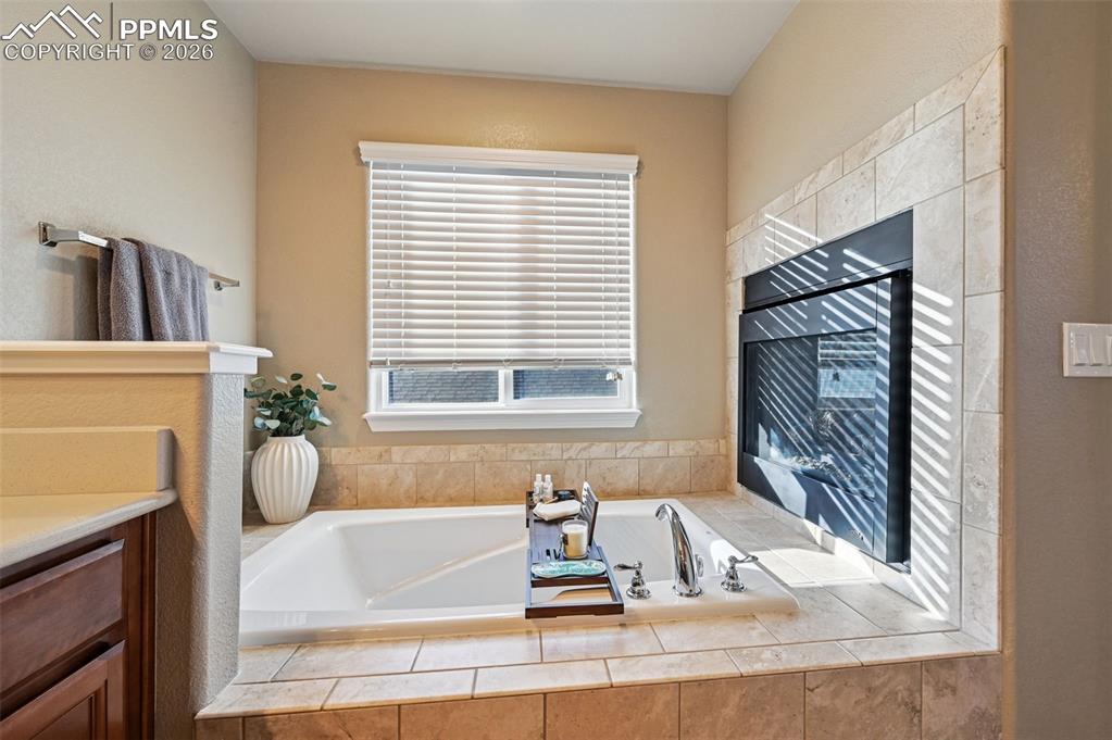 Image 24 of 38: Full bath featuring a garden tub and vanity