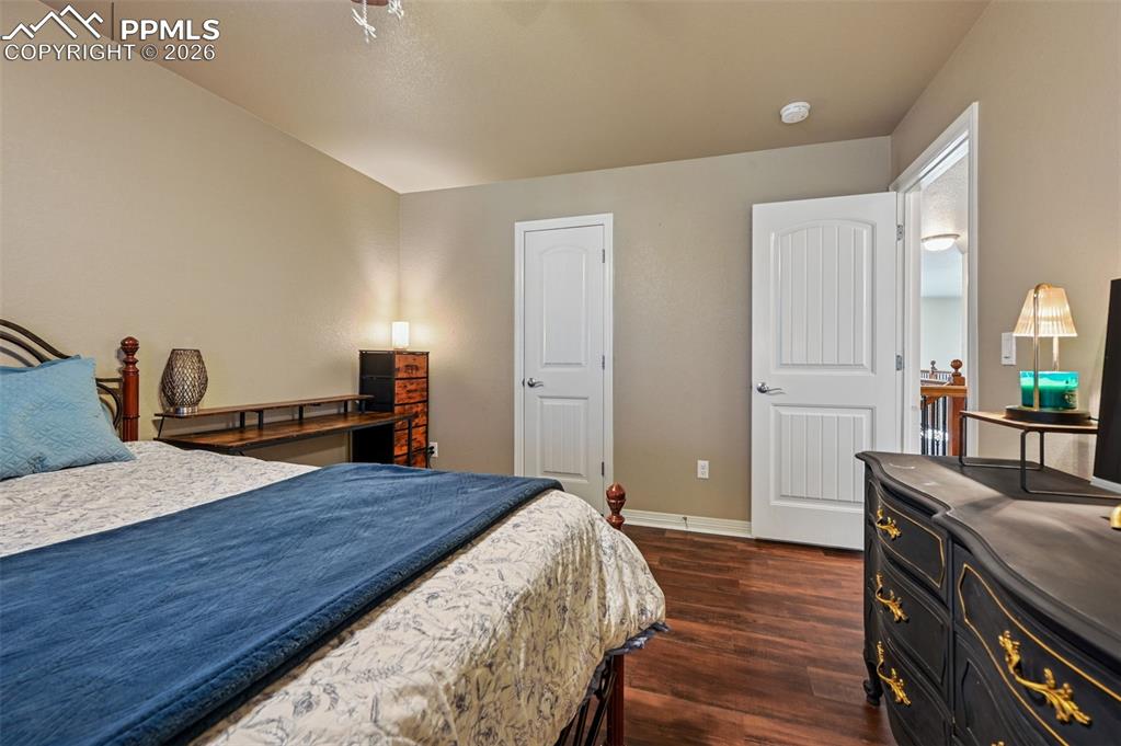 Image 27 of 38: Bedroom featuring dark wood-type flooring and baseboards