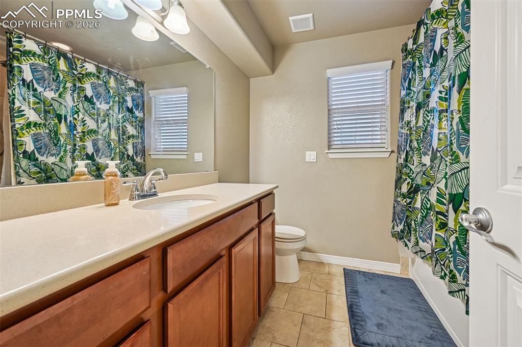 Image 31 of 38: Full bathroom with vanity, light tile patterned floors, and shower / bathtu