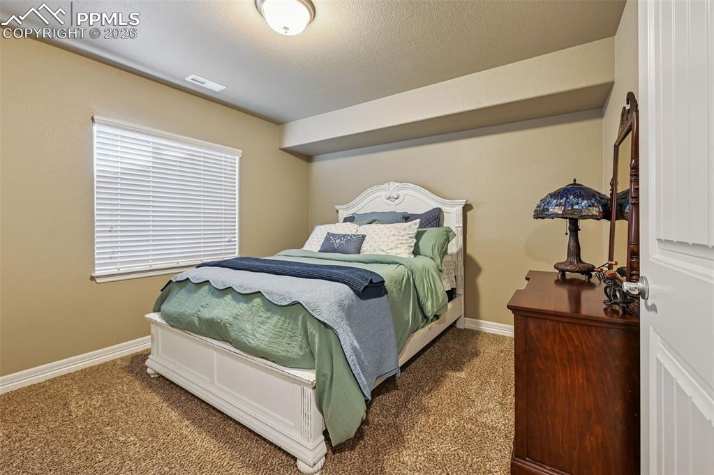 Image 35 of 38: Carpeted bedroom featuring baseboards and a textured ceiling