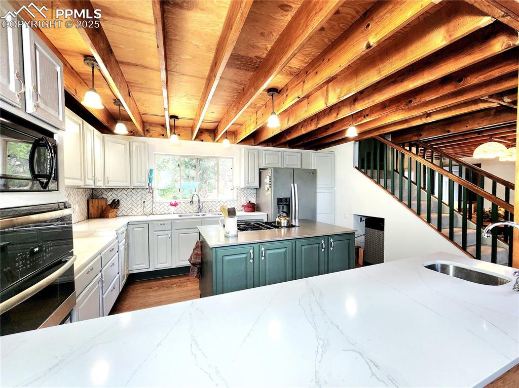 Image 11 of 50: Well appointed kitchen opens to the main living areas and is a cooks dream