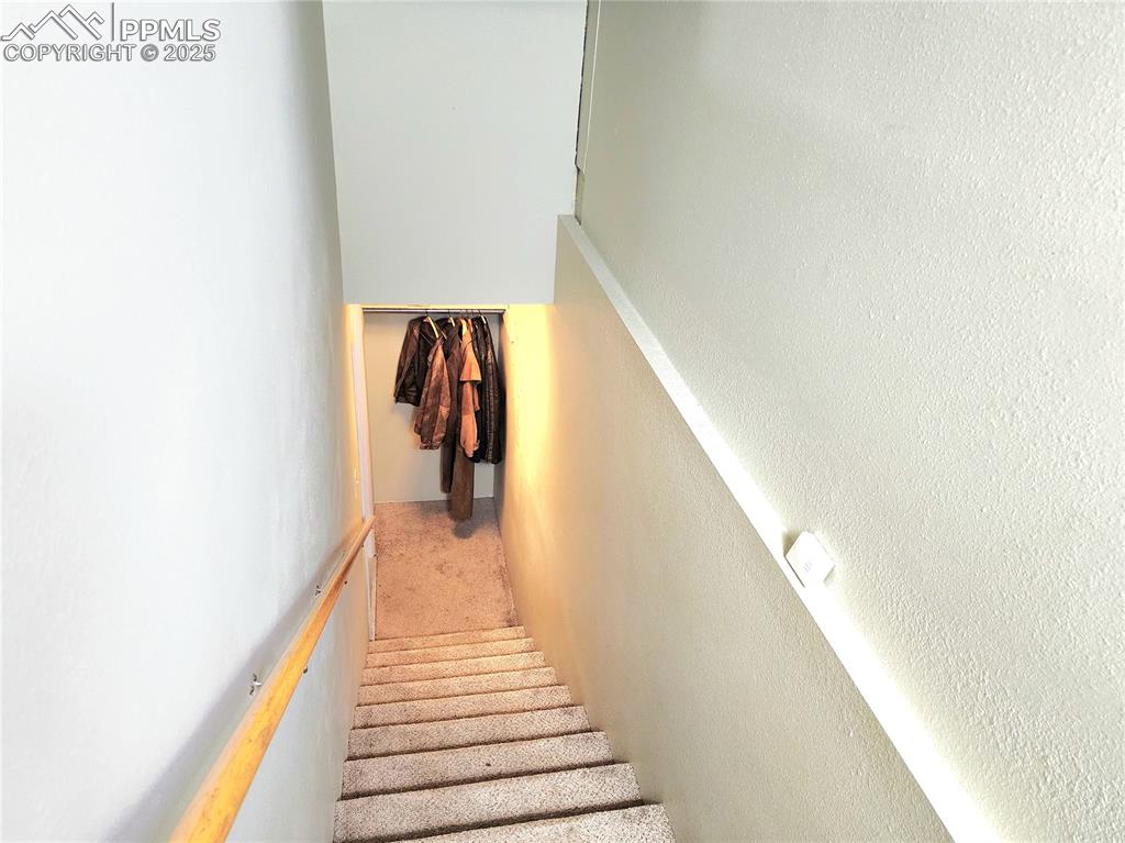 Image 39 of 50: Stairs leading to basement and garage