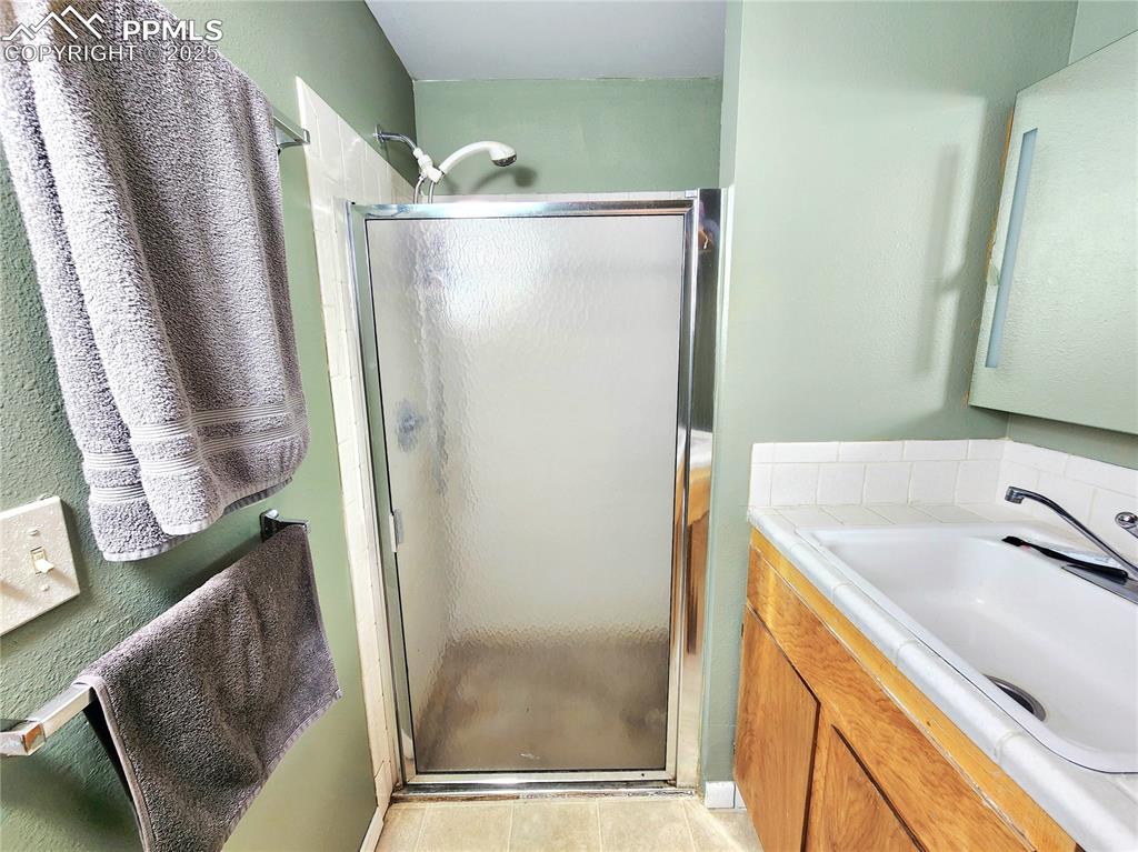 Image 40 of 50: Basement 3/4 bathroom is off of 3rd car garage never used for a vehichle an
