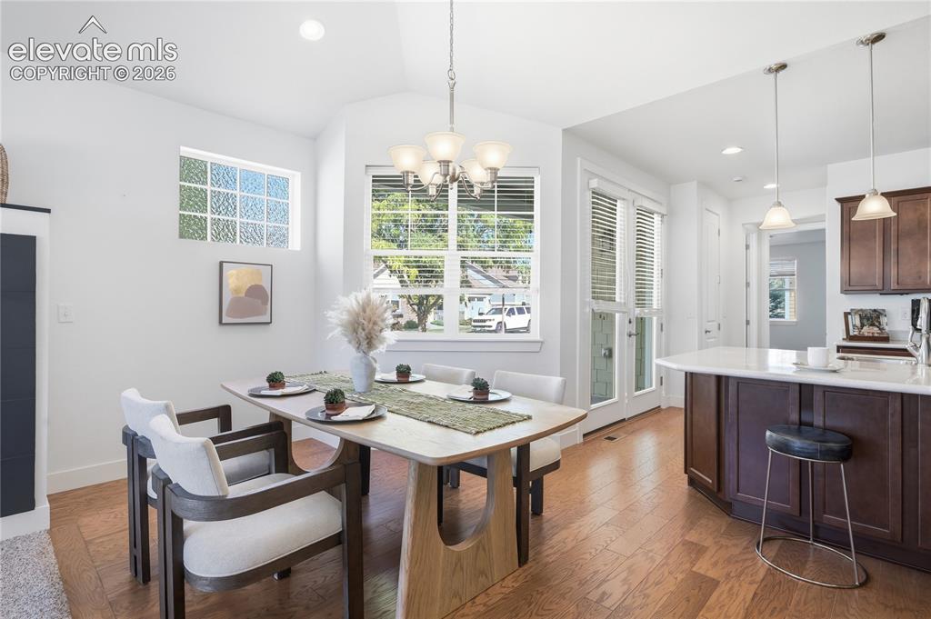 Image 11 of 24: Vaulted ceiling with recessed lighting, wood-finish flooring, glass block w