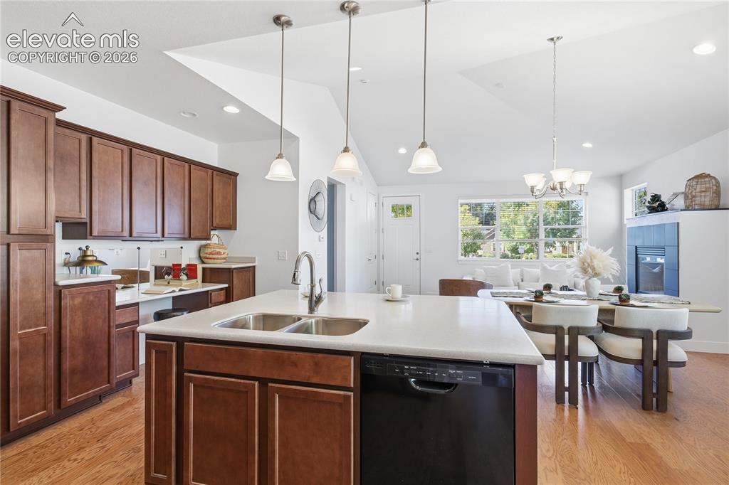 Image 15 of 24: Kitchen island with dual stainless steel sinks and a dishwasher, complement