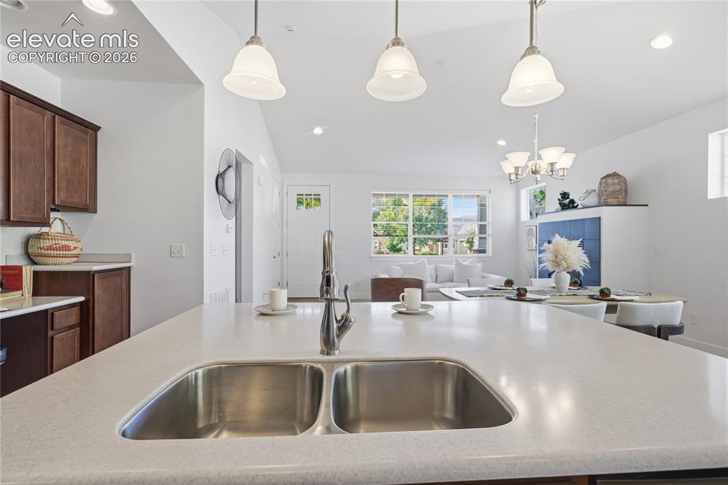 Image 16 of 24: Kitchen island featuring a double basin stainless steel sink with a chrome 