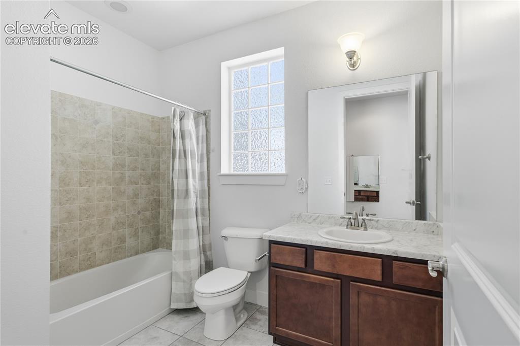 Image 19 of 24: Tub and shower combination with tile surround, vanity with single basin sin