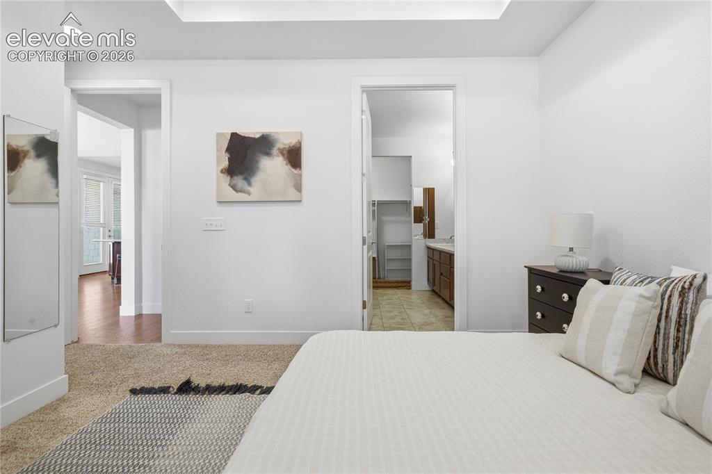 Image 4 of 24: Recessed ceiling lighting, white walls, and carpet flooring