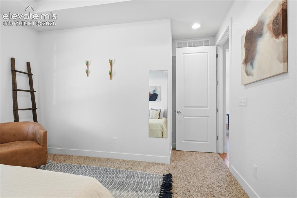 Image 5 of 24: Recessed lighting, tray ceiling, white interior doors, and neutral wall ton