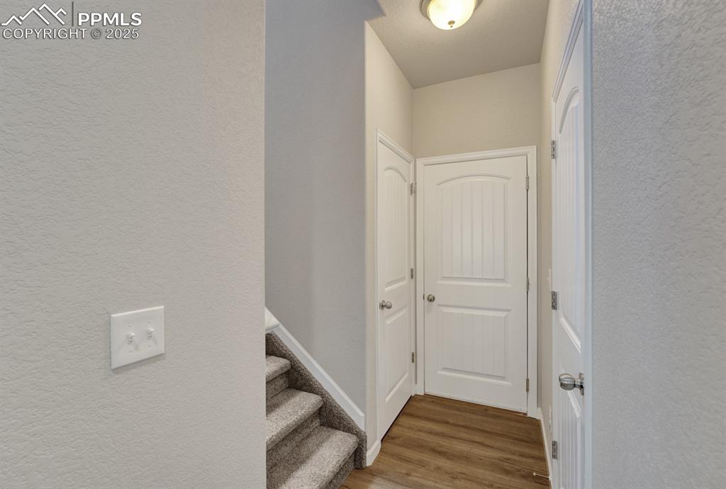 Image 11 of 25: There is a powder bath and attached garage off the main floor.