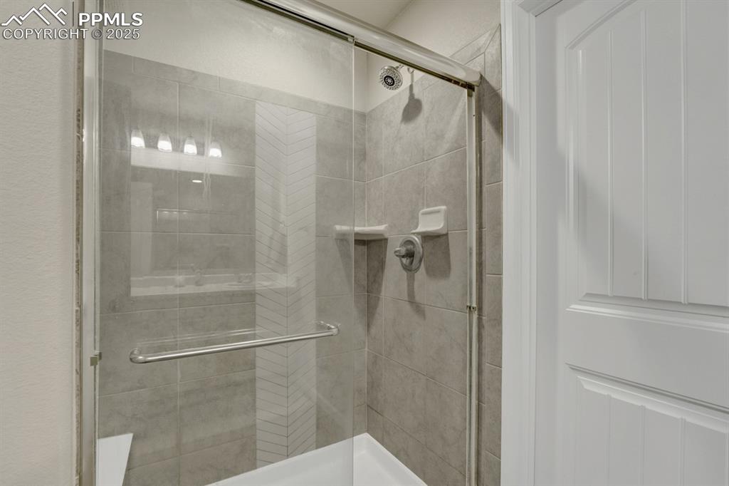 Image 16 of 25: Spacious shower and tile.