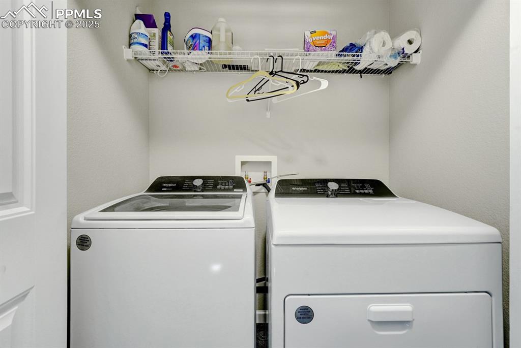 Image 17 of 25: The laundry space is conveniently located on the upper level with the bedro