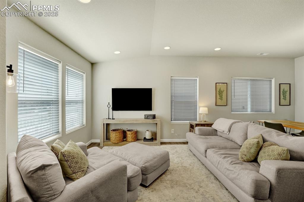 Image 3 of 25: The Living room is bright and open with luxury vinyl flooring and recessed