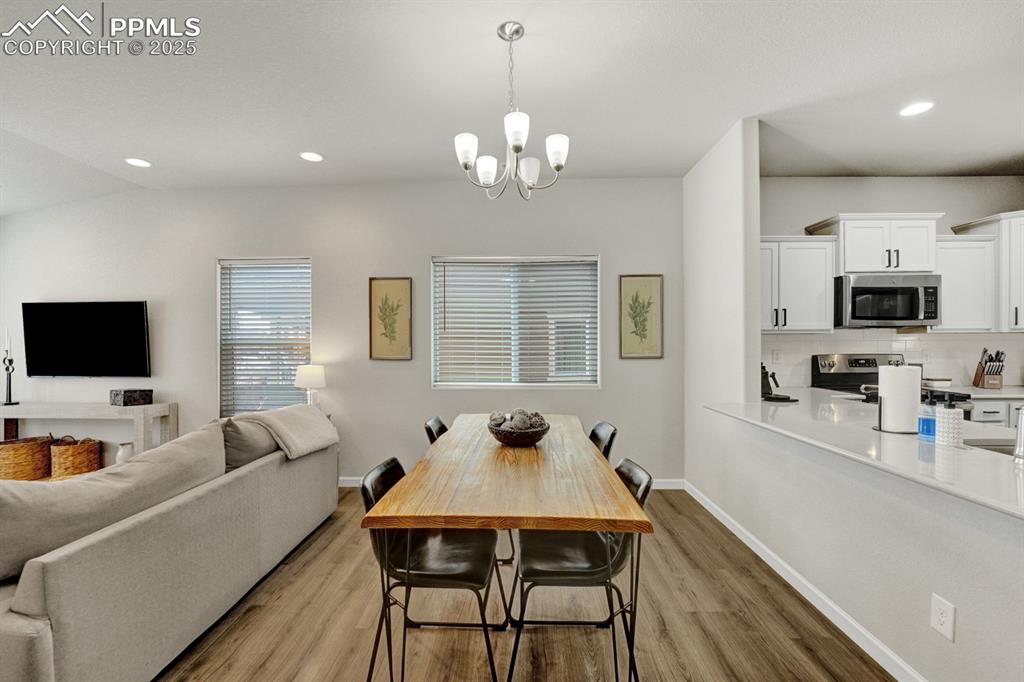 Image 6 of 25: There is plenty of space for a dining table or seating at the bar.