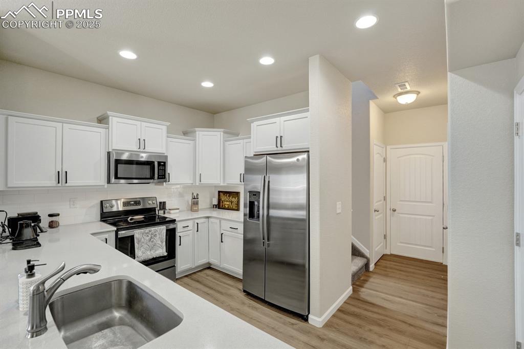 Image 8 of 25: The kitchen is modern with upgraded hardware and stainless appliances.