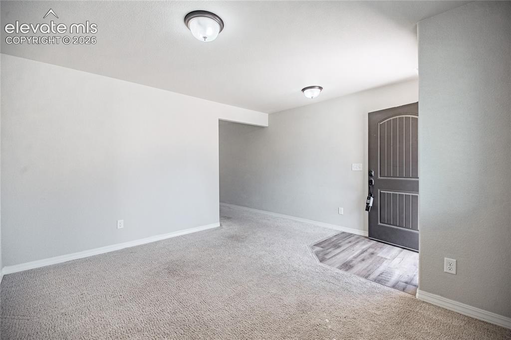 Image 10 of 35: Entryway with wood-finish flooring, a paneled door, and overhead flush moun