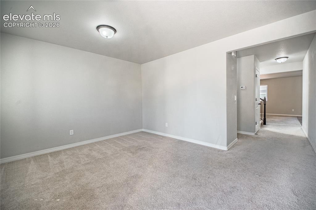 Image 11 of 35: Wall-to-wall carpeting and neutral wall tones create a versatile interior