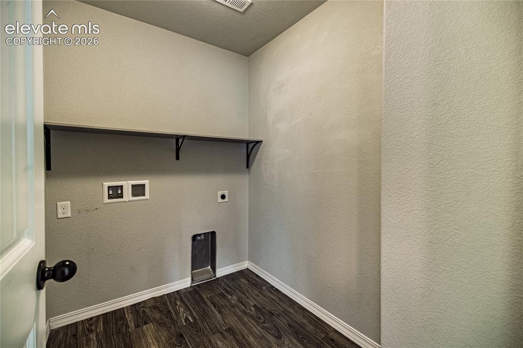 Image 28 of 35: Dedicated utility space featuring a built-in shelf with supports and dark w