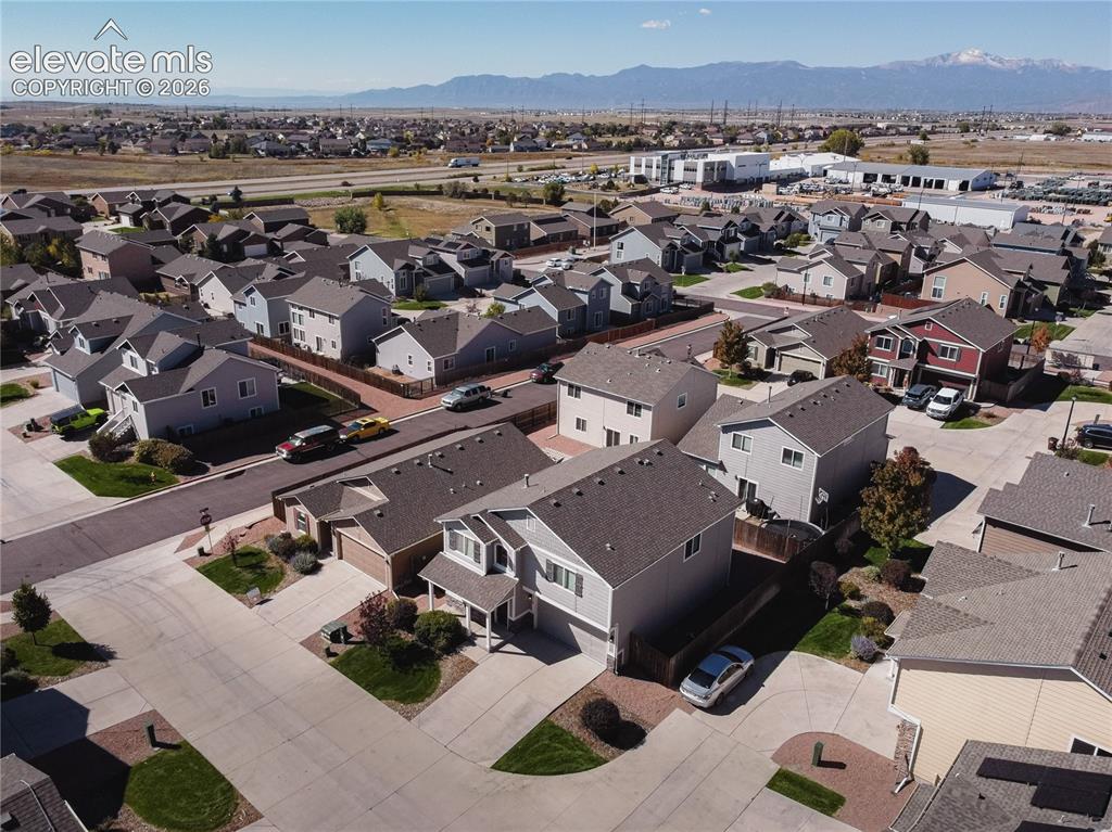Image 33 of 35: Residential neighborhood with varied architectural styles and mountain scen