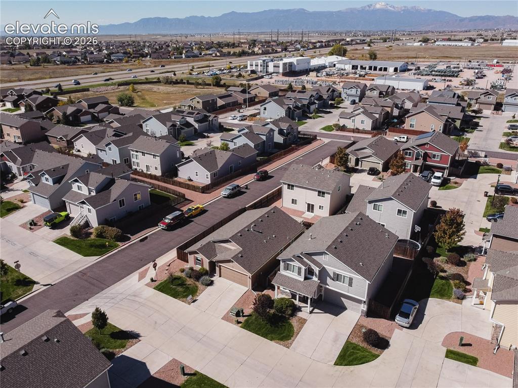 Image 34 of 35: Mountain backdrop, residential street, concrete driveways, paved roads, and