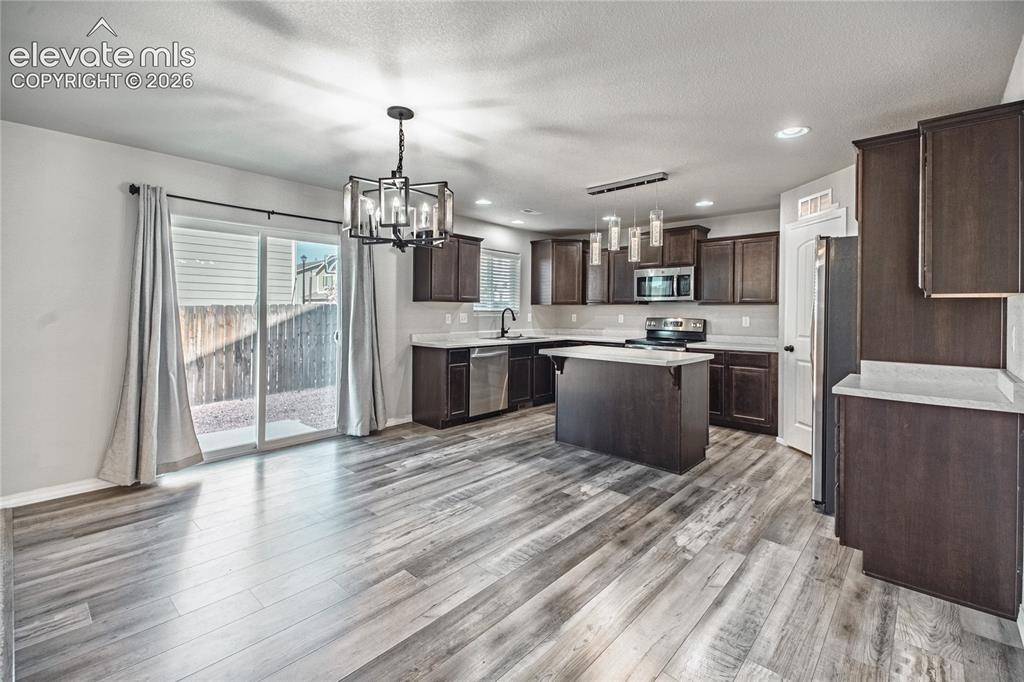 Image 4 of 35: Wood-finish flooring throughout the space