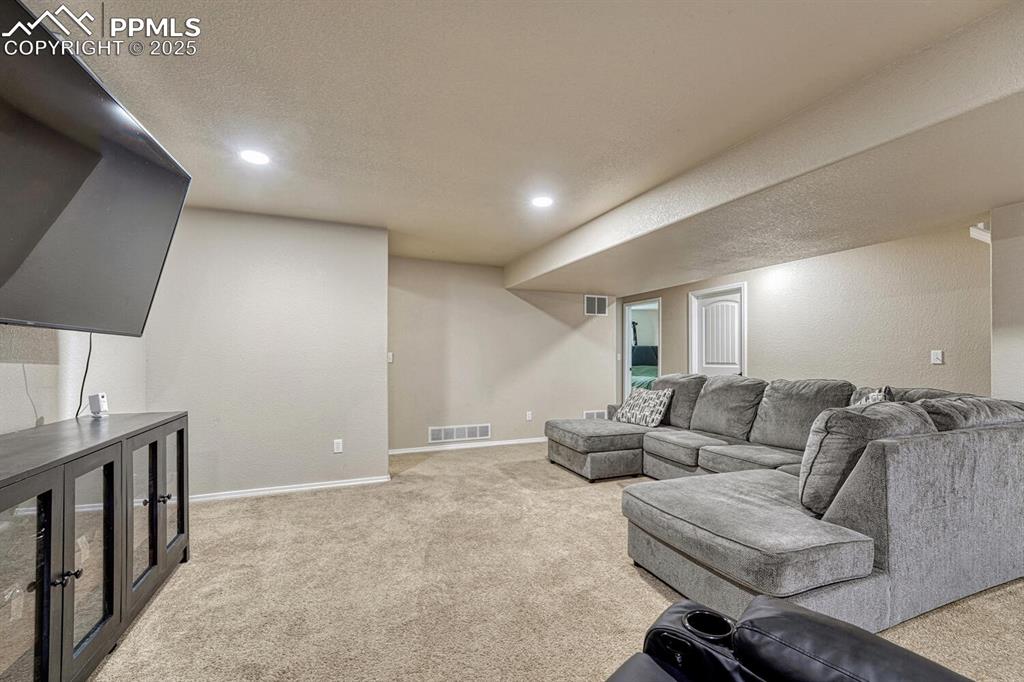 Image 22 of 41: Experience the warmth and comfort of a carpeted living area, perfectly comp